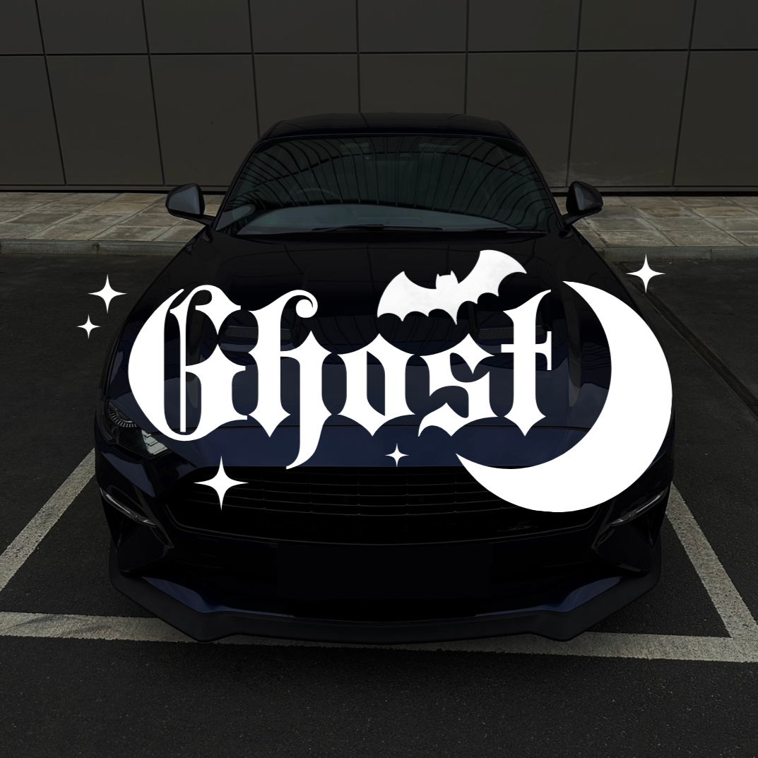 Black car with 'Ghost' logo on a dark tiled floor