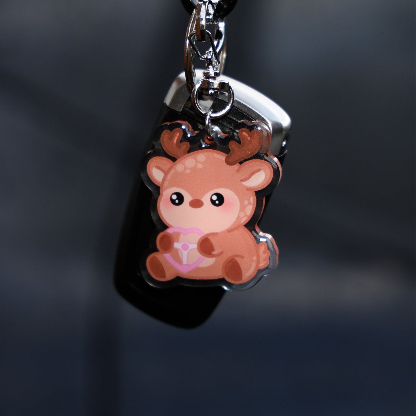 Small deer-shaped keychain on a dark background