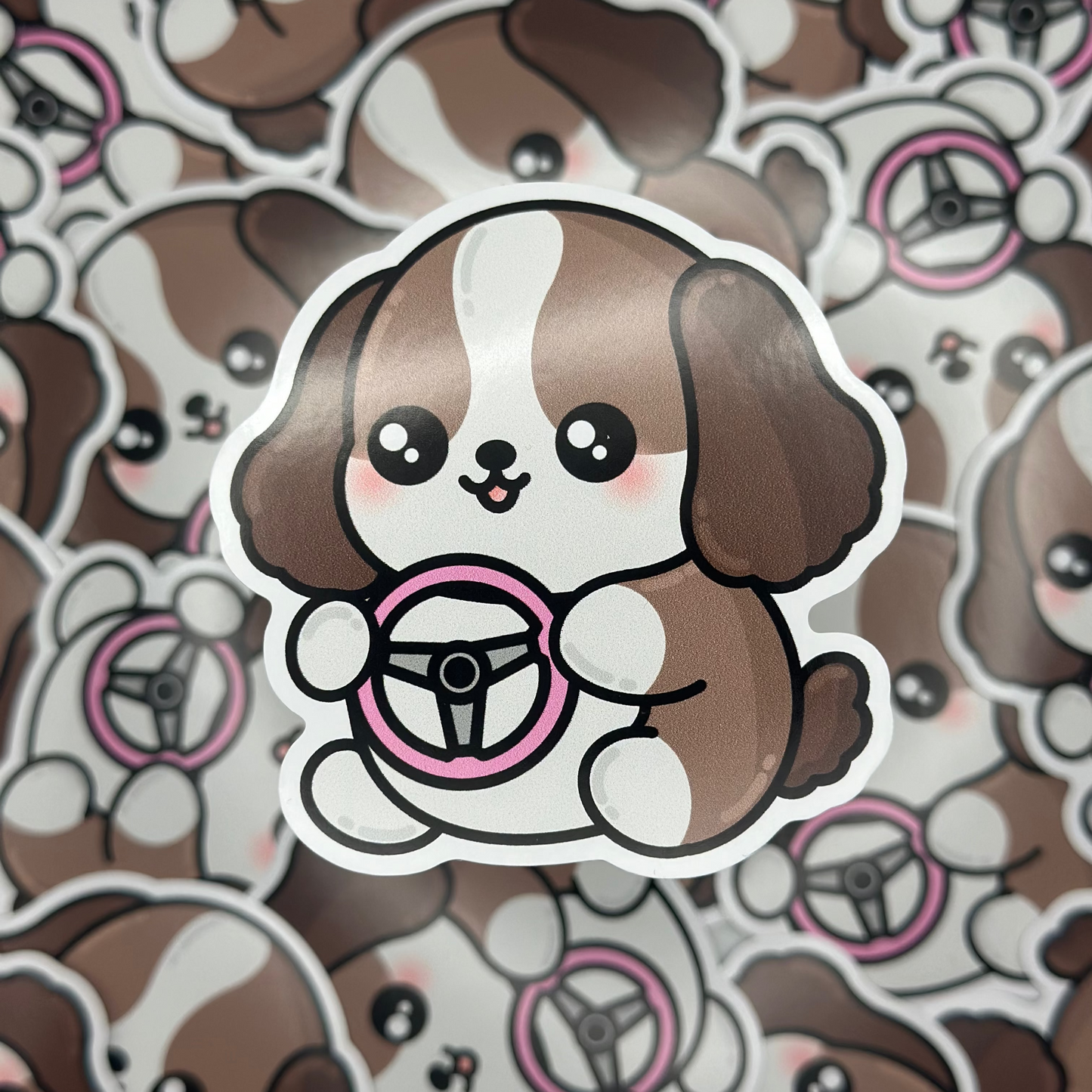 Sticker of a cartoon dog with a steering wheel on a patterned background