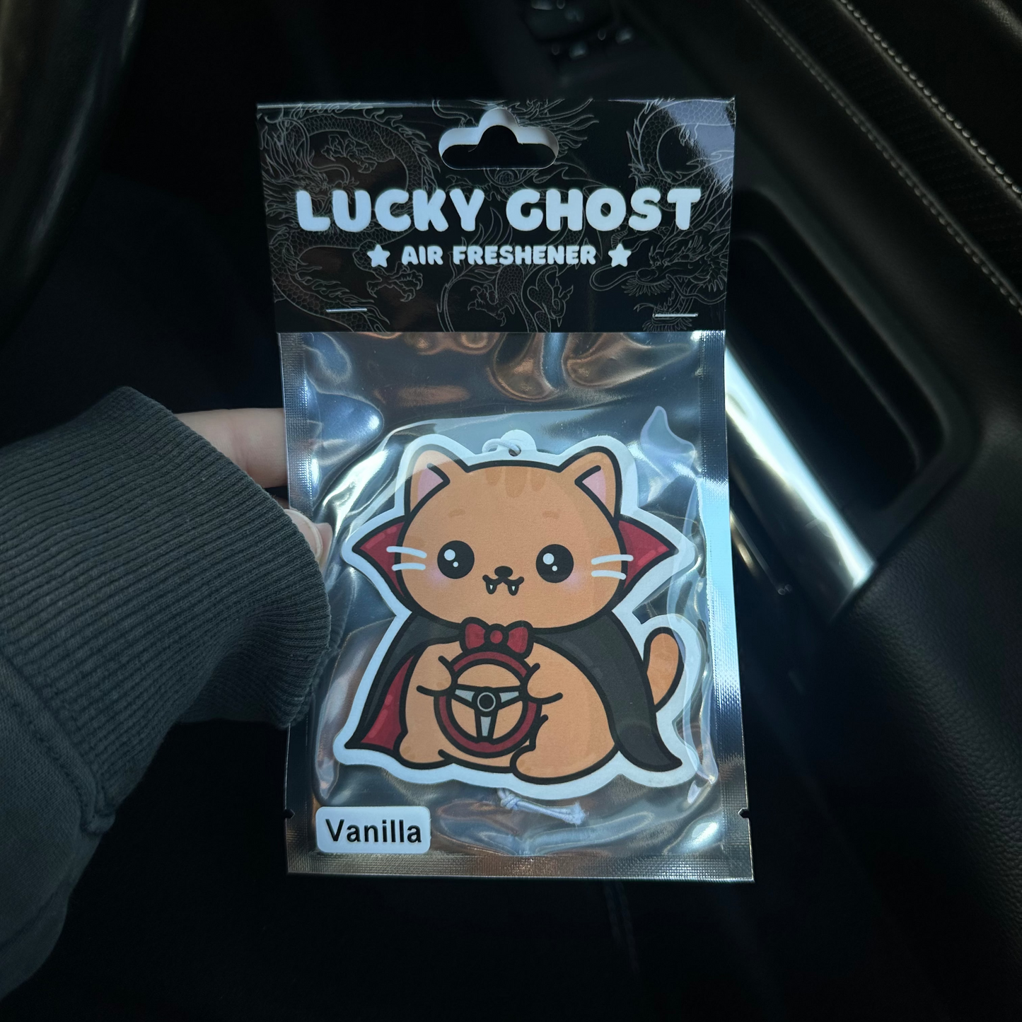 Lucky Ghost air freshener packaging with a cat design on a dark background
