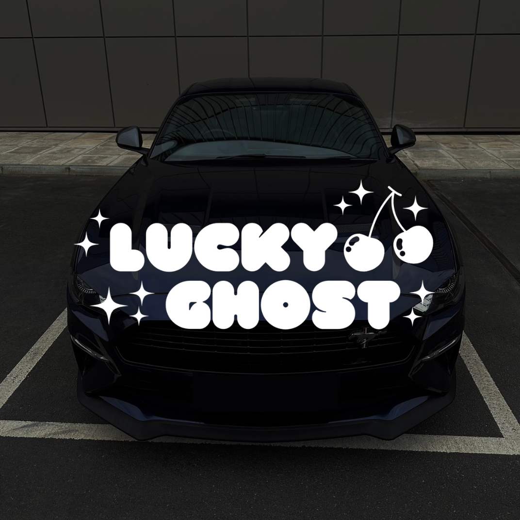 Car with 'Lucky Ghost' decal on a black background