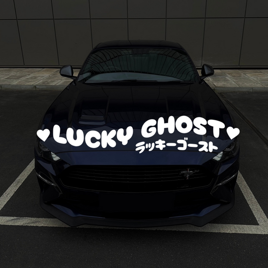 Black car with 'Lucky Ghost' decal on a dark background