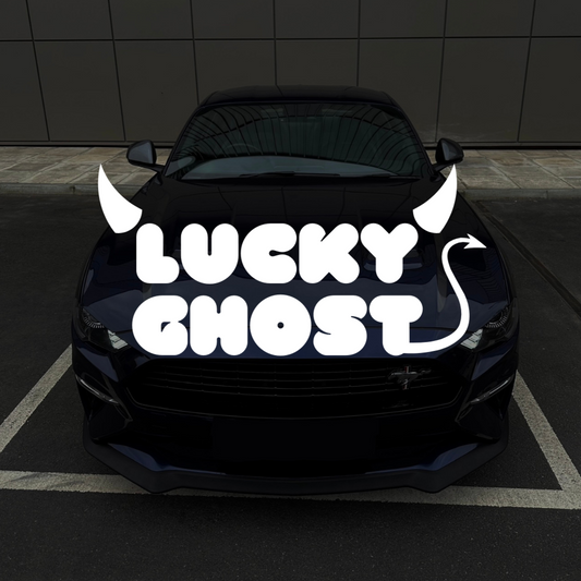 Black car with 'Lucky Ghost' decal on a dark tiled wall background