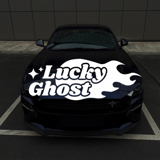 Black car with 'Lucky Ghost' decal on a dark tiled floor
