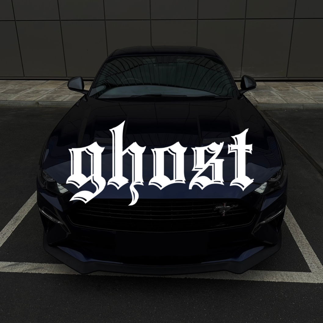 Black car with 'ghost' decal on a dark background