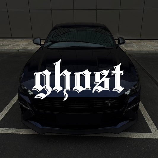 Black car with 'ghost' decal on a dark background