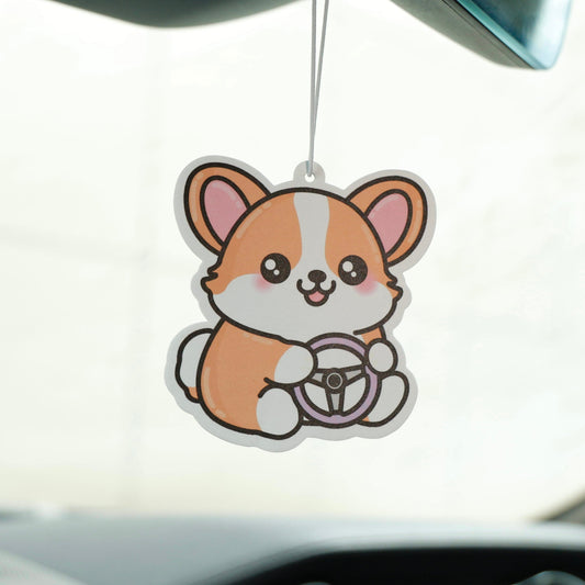 Car air freshener shaped like a cartoon dog hanging from a car's rearview mirror.