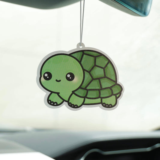 Car air freshener shaped like a turtle hanging from the rearview mirror.