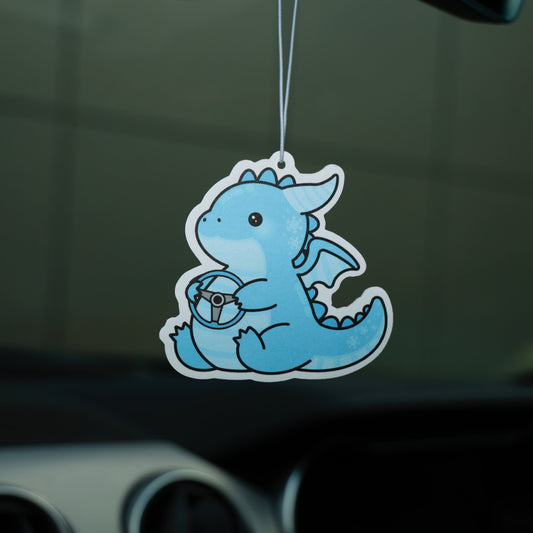 Blue dragon-shaped air freshener hanging from a car's dashboard.