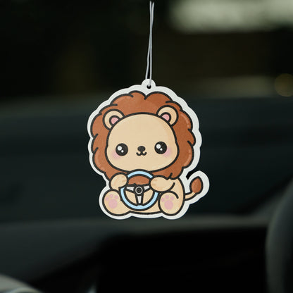 Car air freshener shaped like a lion hanging from a car's rearview mirror.