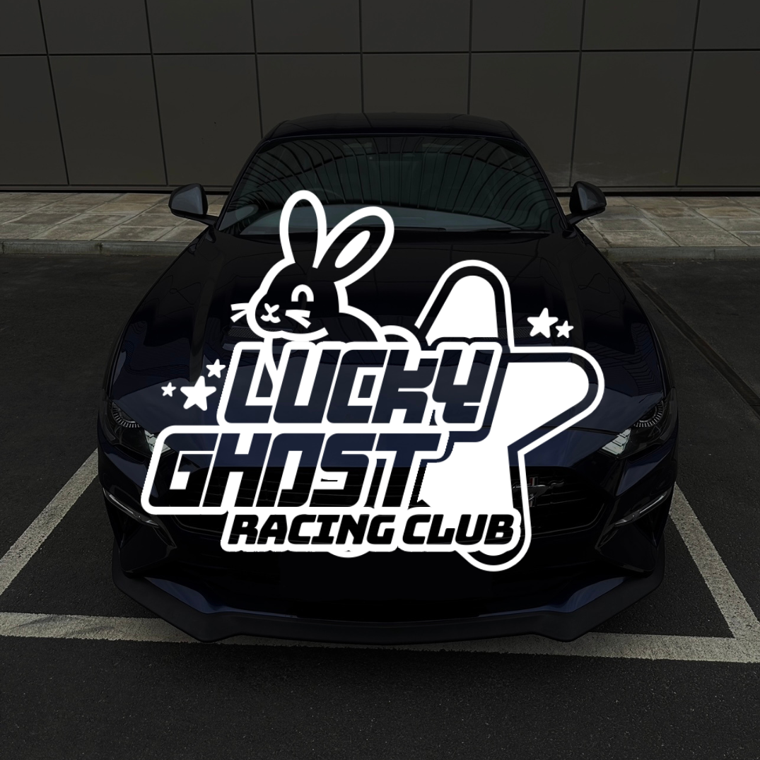 Car with 'Lucky Ghost Racing Club' decal on a black background