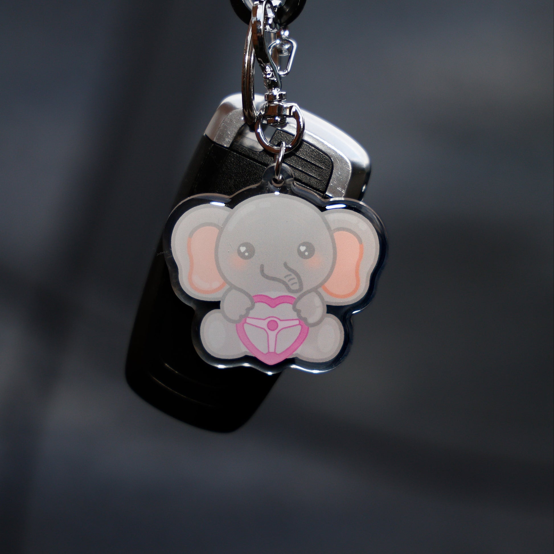 Keychain with a cartoon elephant design on a dark background