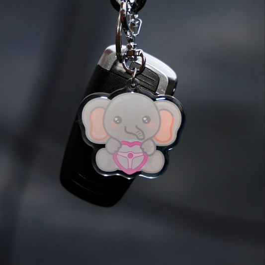 Keychain with a cartoon elephant design on a dark background