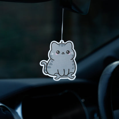 Cat-shaped air freshener hanging from a car's rearview mirror.