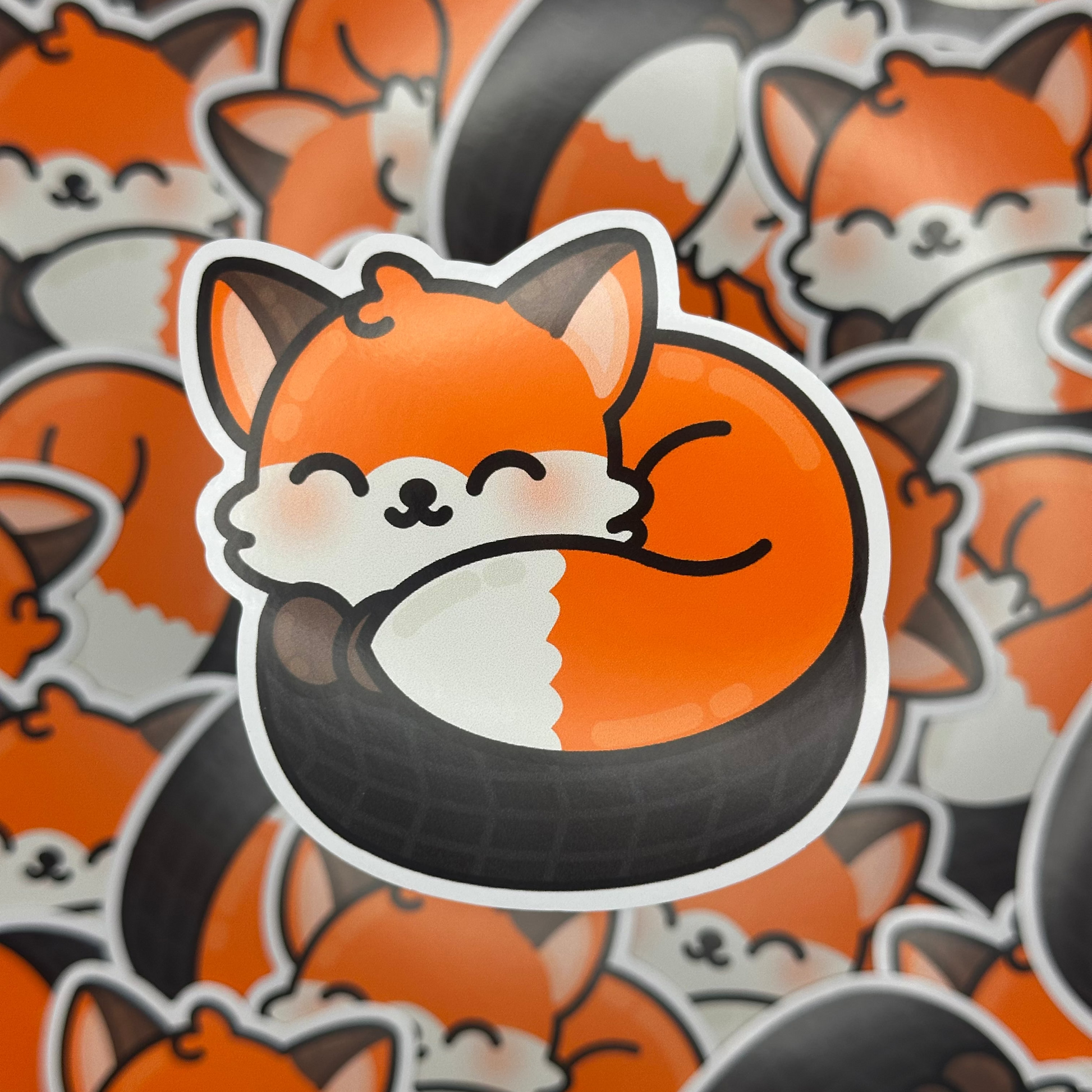 Sticker of a fox with a tire around its neck on a background of similar foxes.
