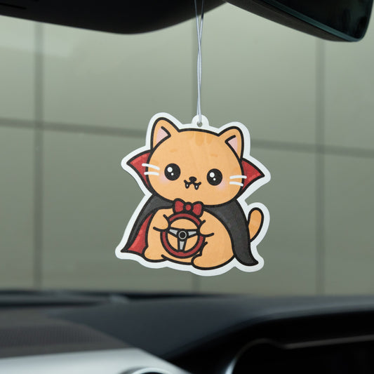 Car air freshener shaped like a cat hanging from a car's rearview mirror.