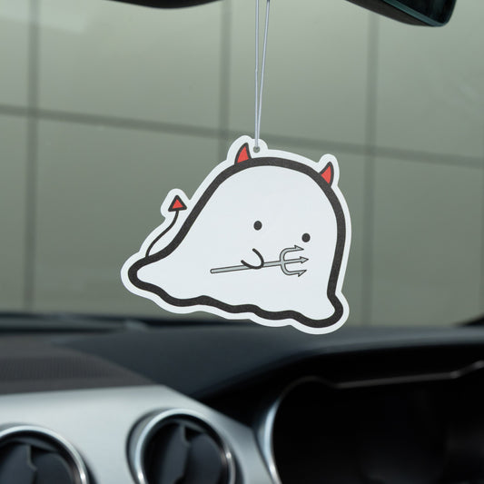 Ghost-shaped air freshener hanging from a car's rearview mirror.