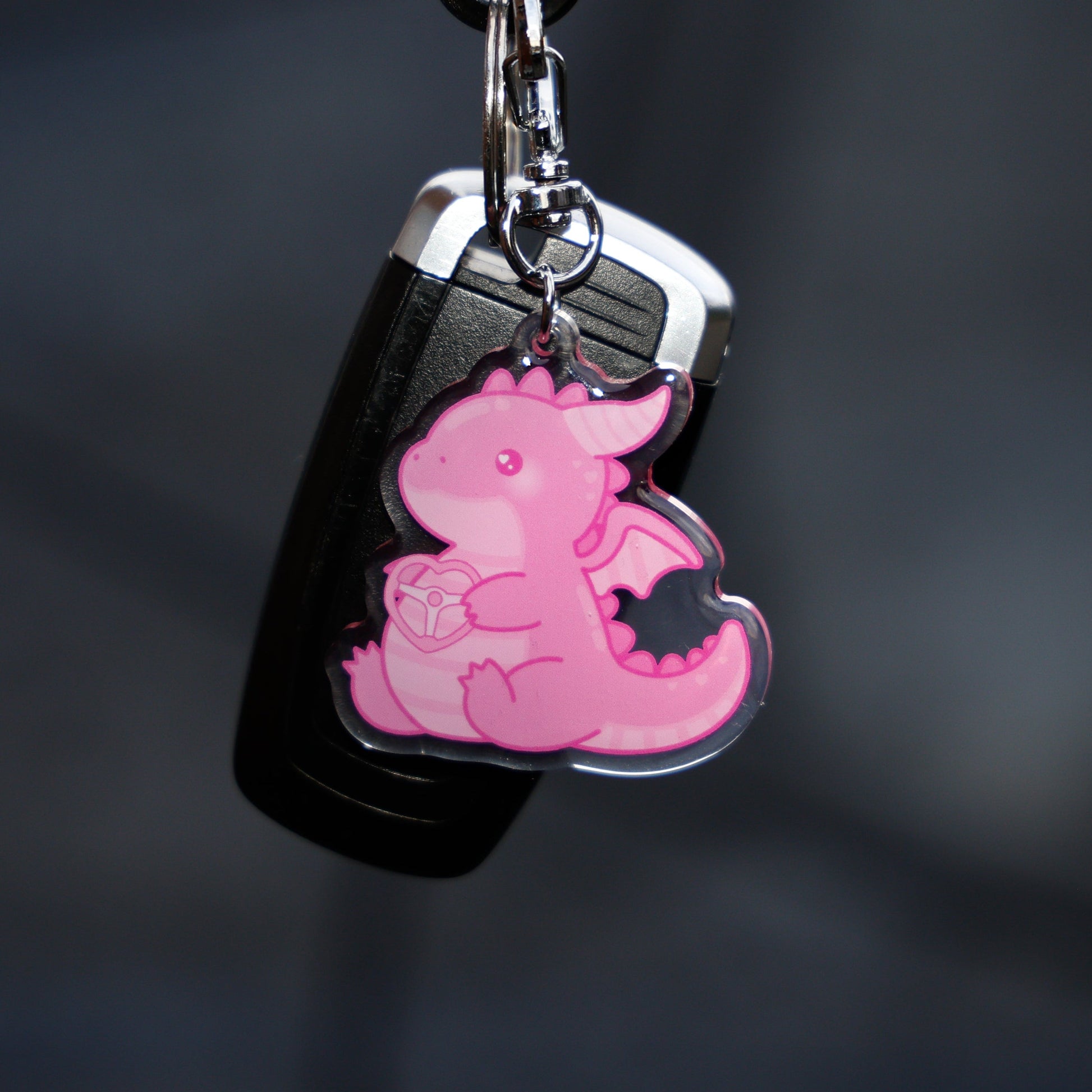 Pink dragon keychain on a black background