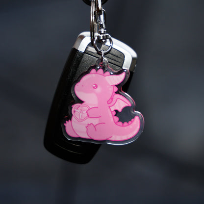 Pink dragon keychain on a black background