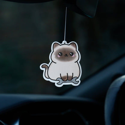 Car air freshener shaped like a cat hanging from the rearview mirror.