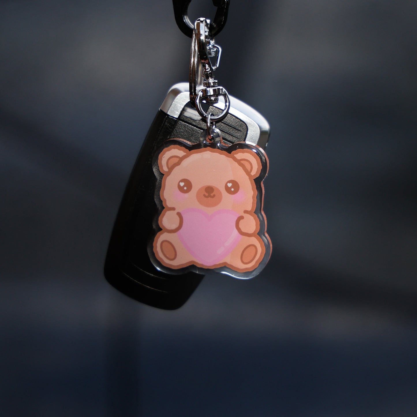 Keychain with a bear design on a dark background