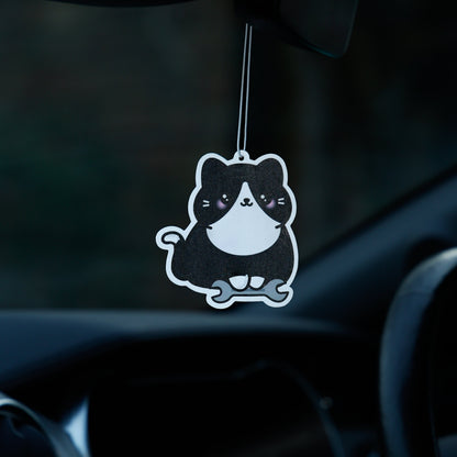 Car air freshener shaped like a cat hanging from the rearview mirror.