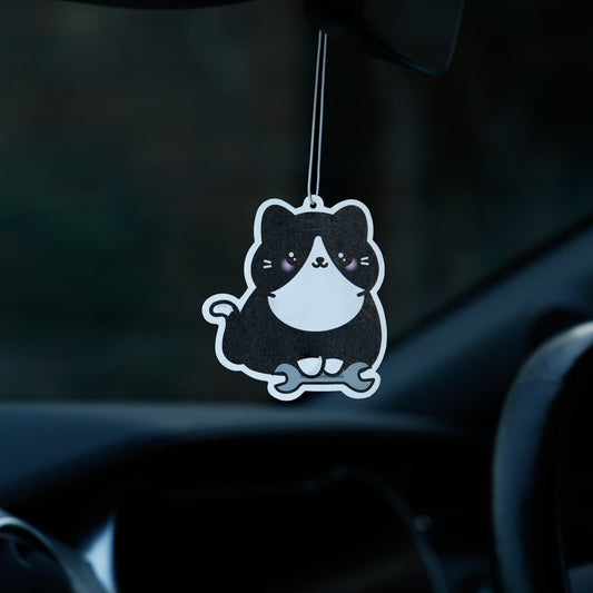 Car air freshener shaped like a cat hanging from the rearview mirror.